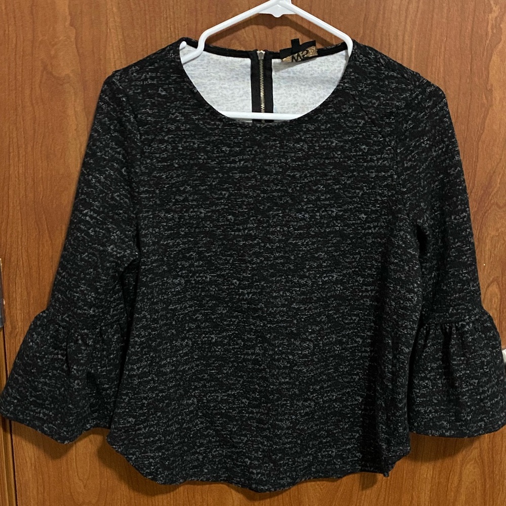 Chic, black, long-sleeved sweater top.